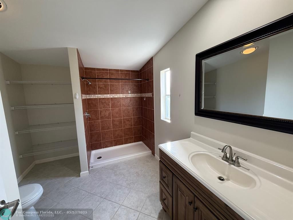 8550 Southwest 23rd Place Davie, FL 33324 - Photo 4 of 9 a bathroom with a sink a toilet and shower