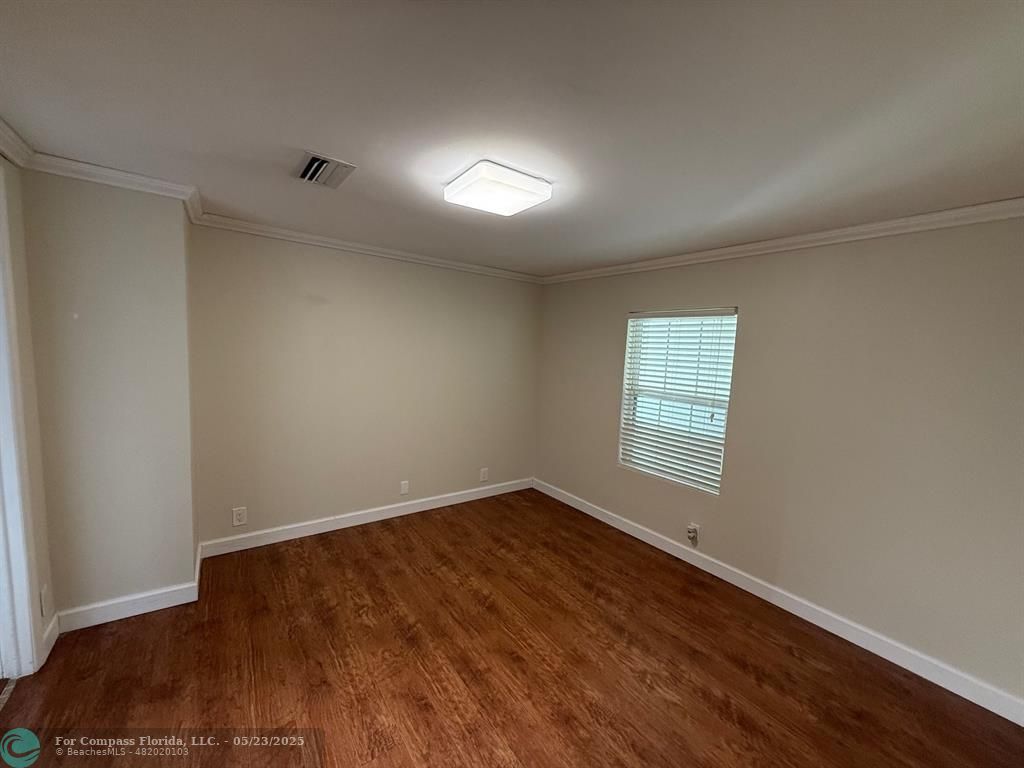 8550 Southwest 23rd Place Davie, FL 33324 - Photo 5 of 9 an empty room with wooden floor and windows