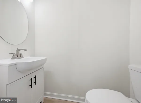 a bathroom with a toilet a sink and mirror