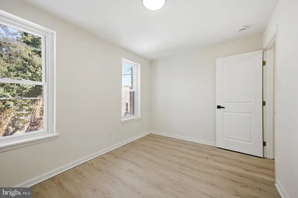 a view of a hallway with a white walls and stairs