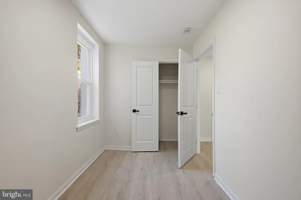 a view of a house with a door and wooden fence