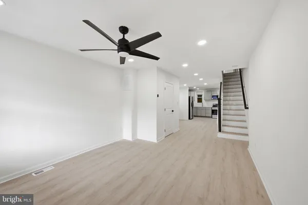a view of a livingroom with a ceiling fan and window