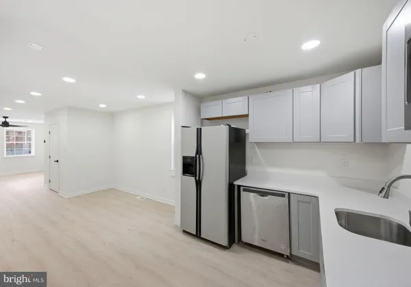 a kitchen with stainless steel appliances a refrigerator sink and cabinets