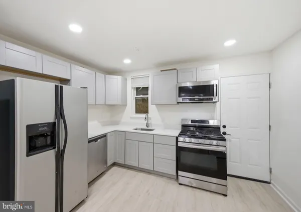 a kitchen with stainless steel appliances a refrigerator stove and sink