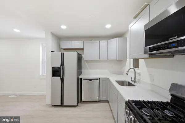 a kitchen with refrigerator and cabinets