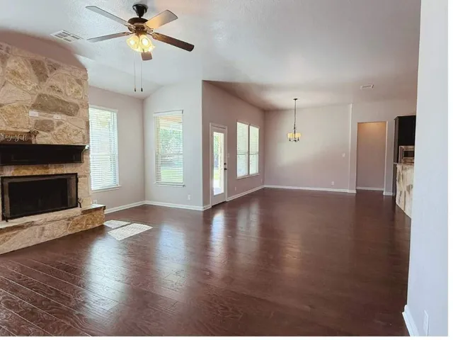 a view of a livingroom with a ceiling fan and window