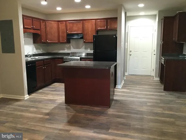 a kitchen with stainless steel appliances granite countertop a refrigerator stove and oven