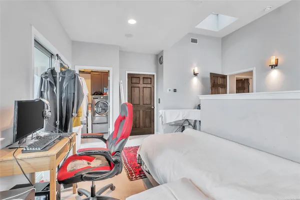 a bedroom with a bed a desk and chair
