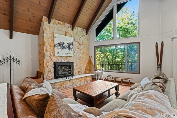 a bathroom with a sink a toilet a mirror a vanity and shower