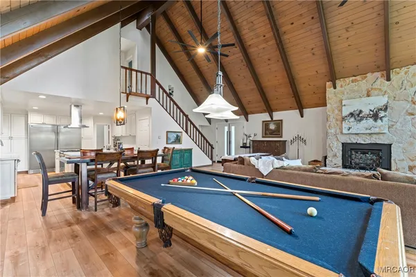 a bedroom with bed and wooden floor