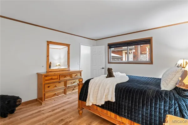 a bed room with a bed window and dresser