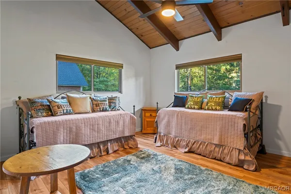 a view of empty room with wooden floor and fireplace