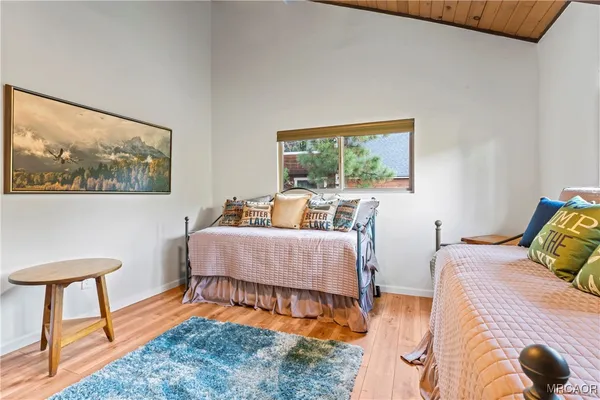 a room with a large window and bed