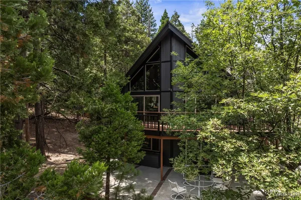 an aerial view of a house with yard and outdoor seating