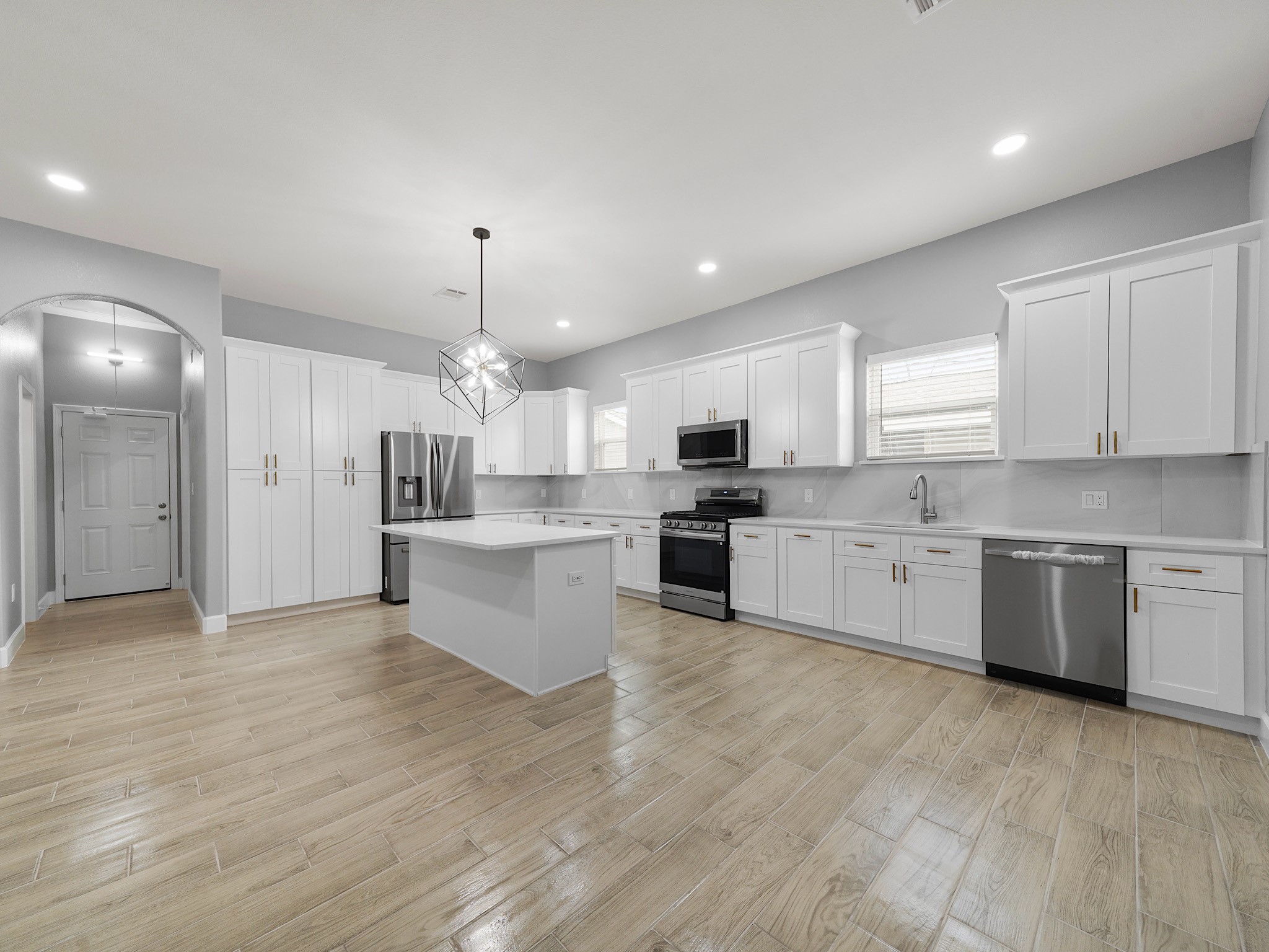 2448 Areba Street Houston, TX 77091 - Photo 7 of 19 The grand-scale kitchen offers an impressive amount of space, featuring expansive countertops, abundant cabinetry, and a large center island—all designed to give you room to cook, gather, and entertain with ease.
