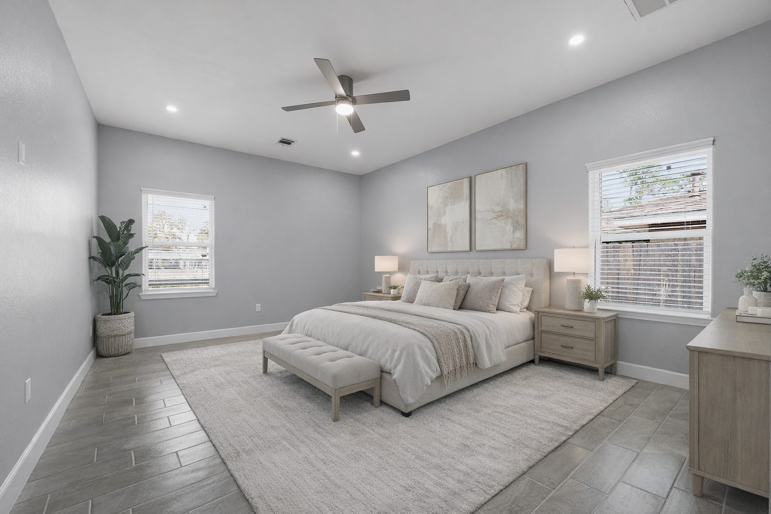 2448 Areba Street Houston, TX 77091 - Photo 8 of 19 Virtually staged. Spacious primary retreat with soaring ceilings, abundant natural light, and room for a king-size bed and sitting area. Enjoy a spa-inspired en-suite bath featuring a soaking tub and separate shower for everyday relaxation.