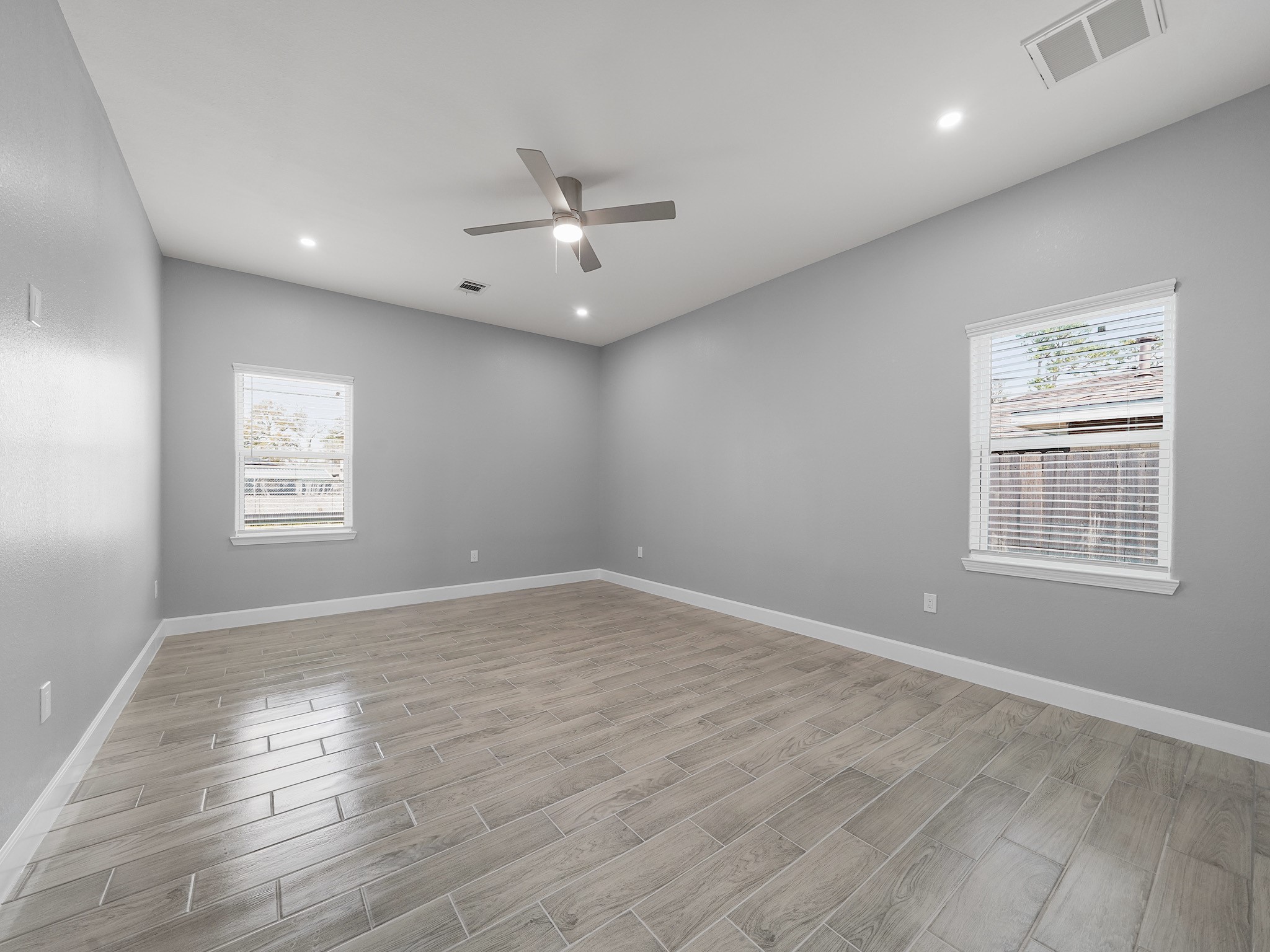 2448 Areba Street Houston, TX 77091 - Photo 9 of 19 Retreat to the spacious primary suite, designed for relaxation with ample room for a king-size bed and additional seating.