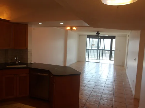 a kitchen with granite countertop a sink a stove and cabinets