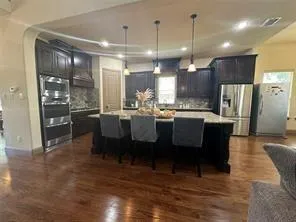 a large kitchen with a table and chairs