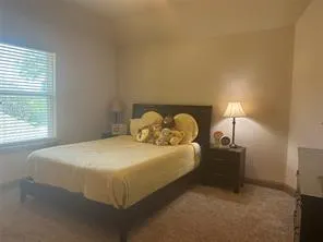 a bedroom with a bed and a lamp