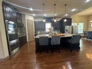 a large kitchen with a table and chairs