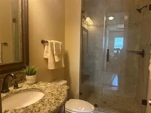 a bathroom with a sink toilet and shower
