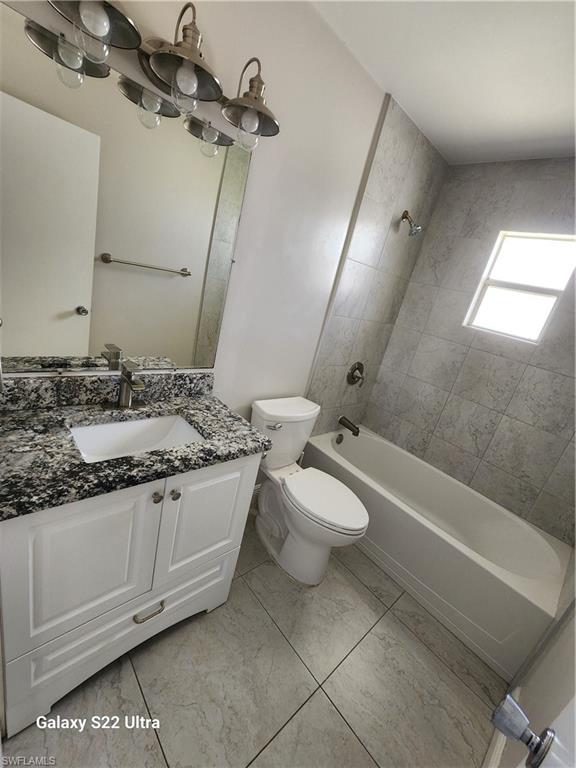 3325 Airport Road North, Unit N8 Naples, FL 34105 - Photo 19 of 22 a bathroom with a granite countertop sink a toilet and bathtub