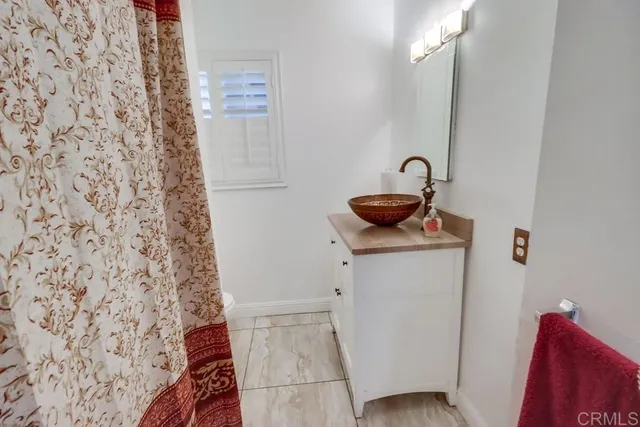 a bathroom with a shower and a sink