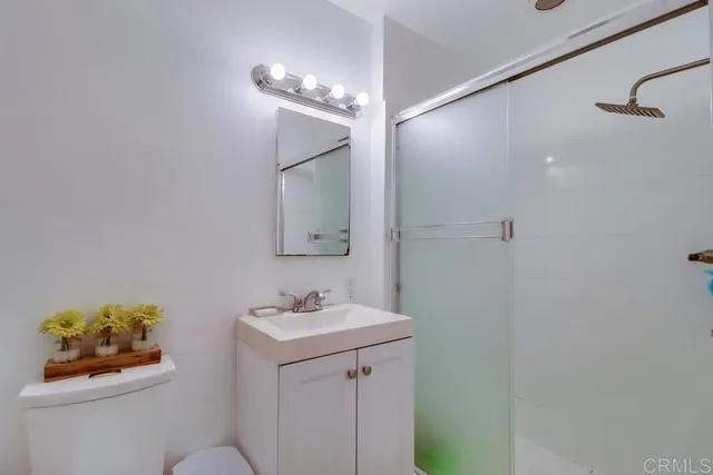 a bathroom with a sink mirror and vanity