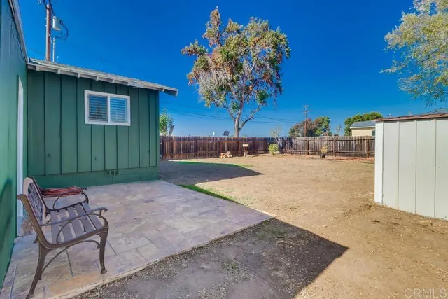 a view of backyard with seating area
