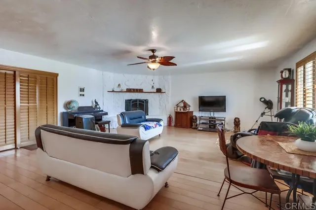 a living room with furniture a fireplace and a flat screen tv