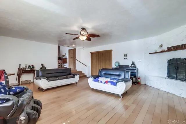a bedroom with furniture and a wooden floor