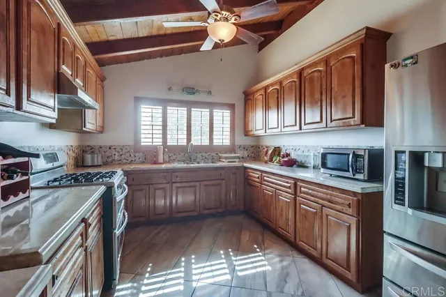 a kitchen with stainless steel appliances granite countertop a sink and cabinets