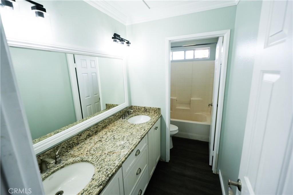 1464 Augusta Street Beaumont, CA 92223 - Photo 20 of 32 a bathroom with a granite countertop sink and a mirror