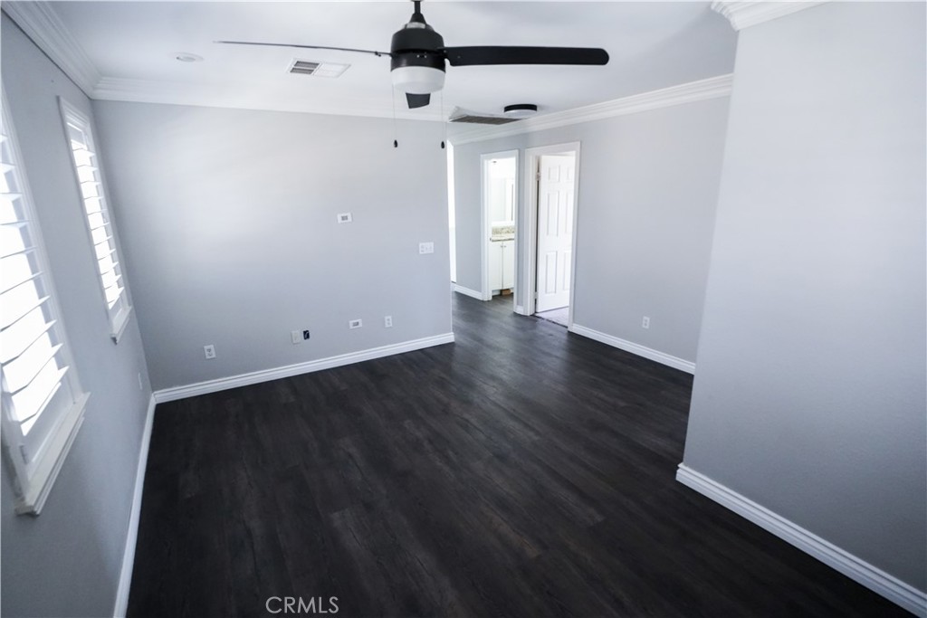 1464 Augusta Street Beaumont, CA 92223 - Photo 27 of 32 an empty room with wooden floor and windows