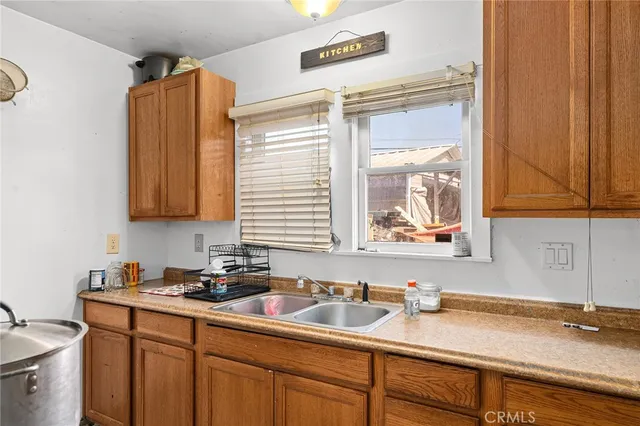a kitchen with sink window and cabinets