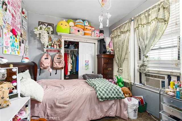 a bedroom with bed and window