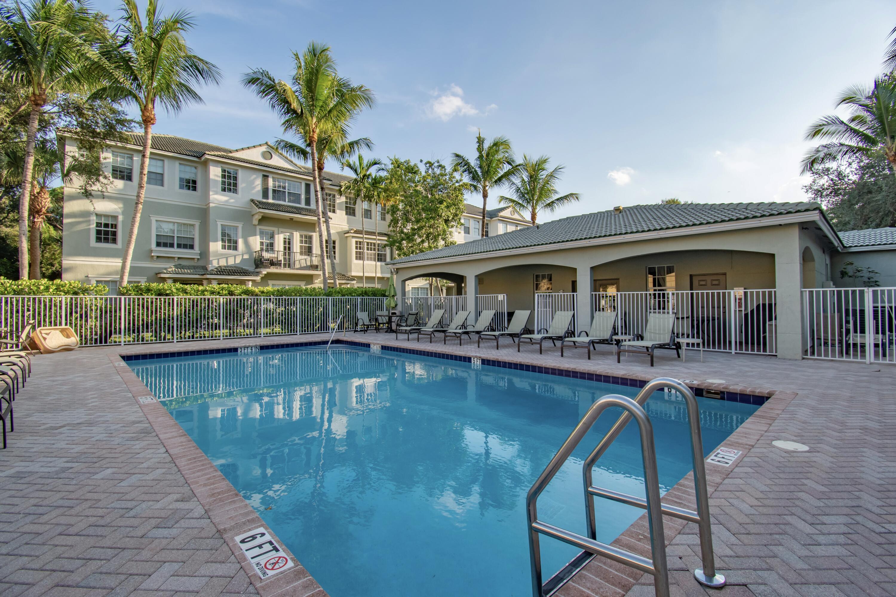 a view of house with swimming pool and sitting area