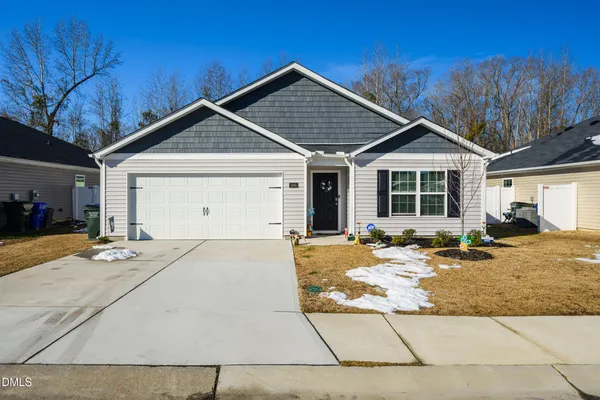a front view of a house with a yard and garage