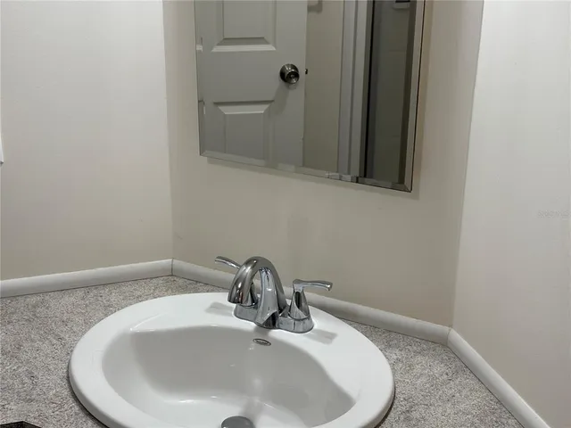 a bathroom with a sink and mirror