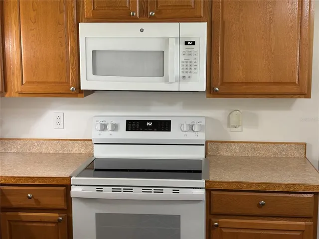 a stove top oven sitting inside of a kitchen