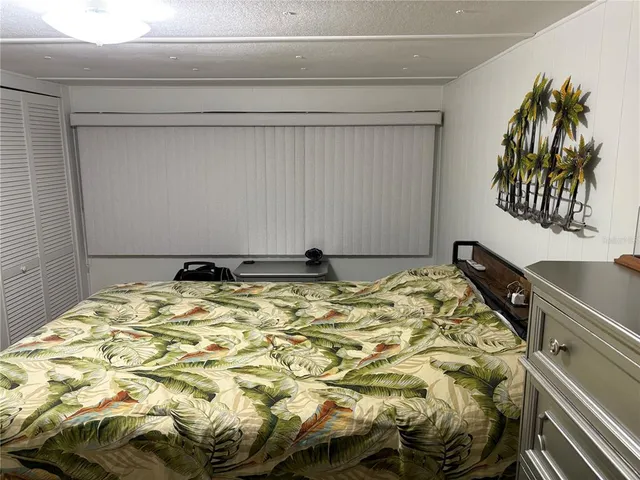 a bed with a black and white comforter