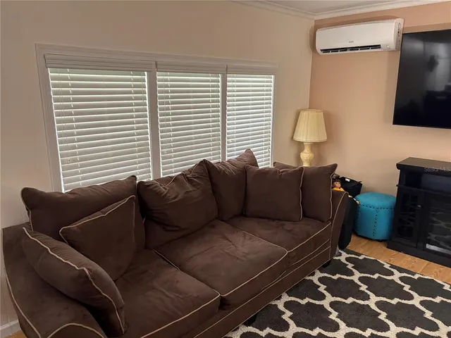 a view of a livingroom with furniture and a flat screen tv