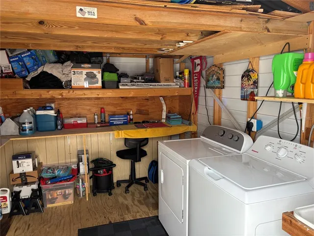 a utility room with dryer washer and other items