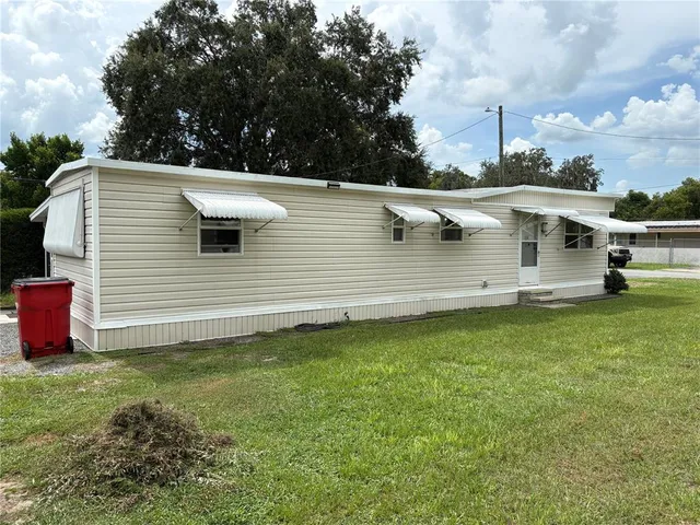 a view of a backyard with sitting area