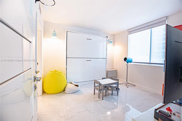 a living room with a table and chairs