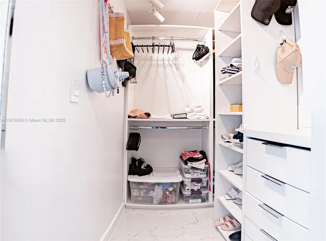 a bedroom with a large bed and a flat screen tv