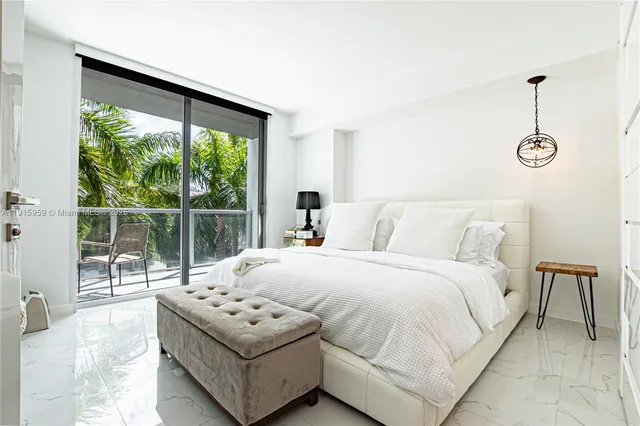 a bedroom with a bed and a large window