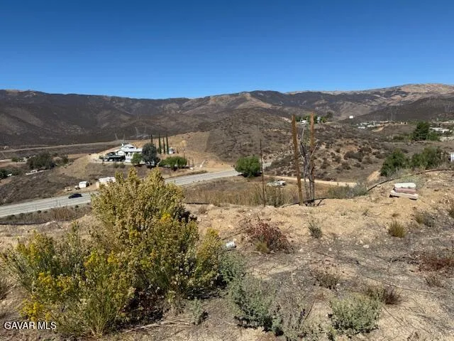 a view of a mountain with wooden fence