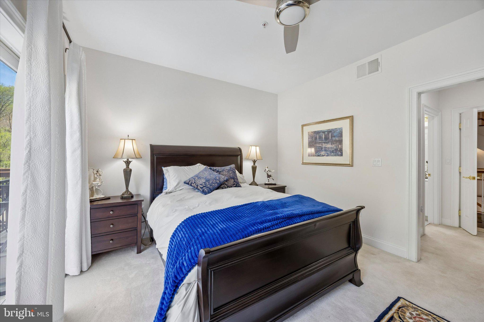 126 Bancroft Mills Road, Unit 14 Wilmington, DE 19806 - Photo 21 of 35 a bedroom with a bed and a night stand